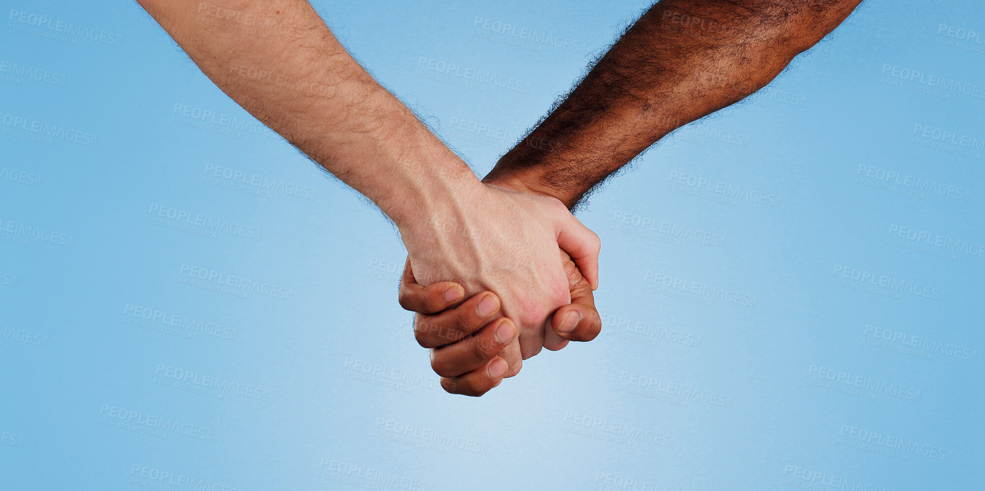 Buy stock photo Love, unity and people holding hands in studio for change, collaboration and kindness in solidarity. Friends, trust and gesture of support on blue background for human rights, care or racial equality