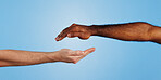 Hands, reaching and people with support in studio for teamwork, care and help in collaboration. Friends, trust and gesture of unity by blue background for solidarity, kindness and understanding