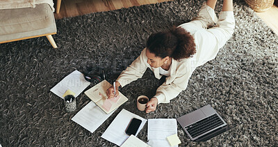 Buy stock photo Coffee, laptop and writing with business woman on floor in living room of home for research. Computer, notebook and planning with African employee in apartment for online administration from above