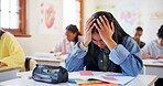 Frustrated girl, student and book with stress for exam, test or evaluation in classroom at school. Young, female person or teenager with migraine, anxiety or nerves for bad assesment or assignment