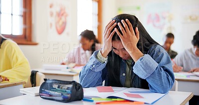 Buy stock photo Frustrated girl, student and book with stress for exam, test or evaluation in classroom at school. Young, female person or teenager with migraine, anxiety or nerves for bad assesment or assignment