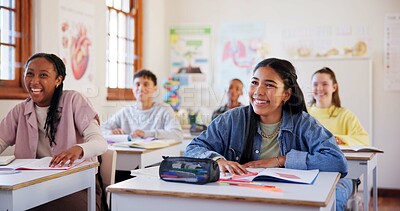 Buy stock photo Happy teenagers, students and laughing with humor in classroom for funny joke together at school. Young, group or learners with smile, books or desk for fun education, learning or youth development