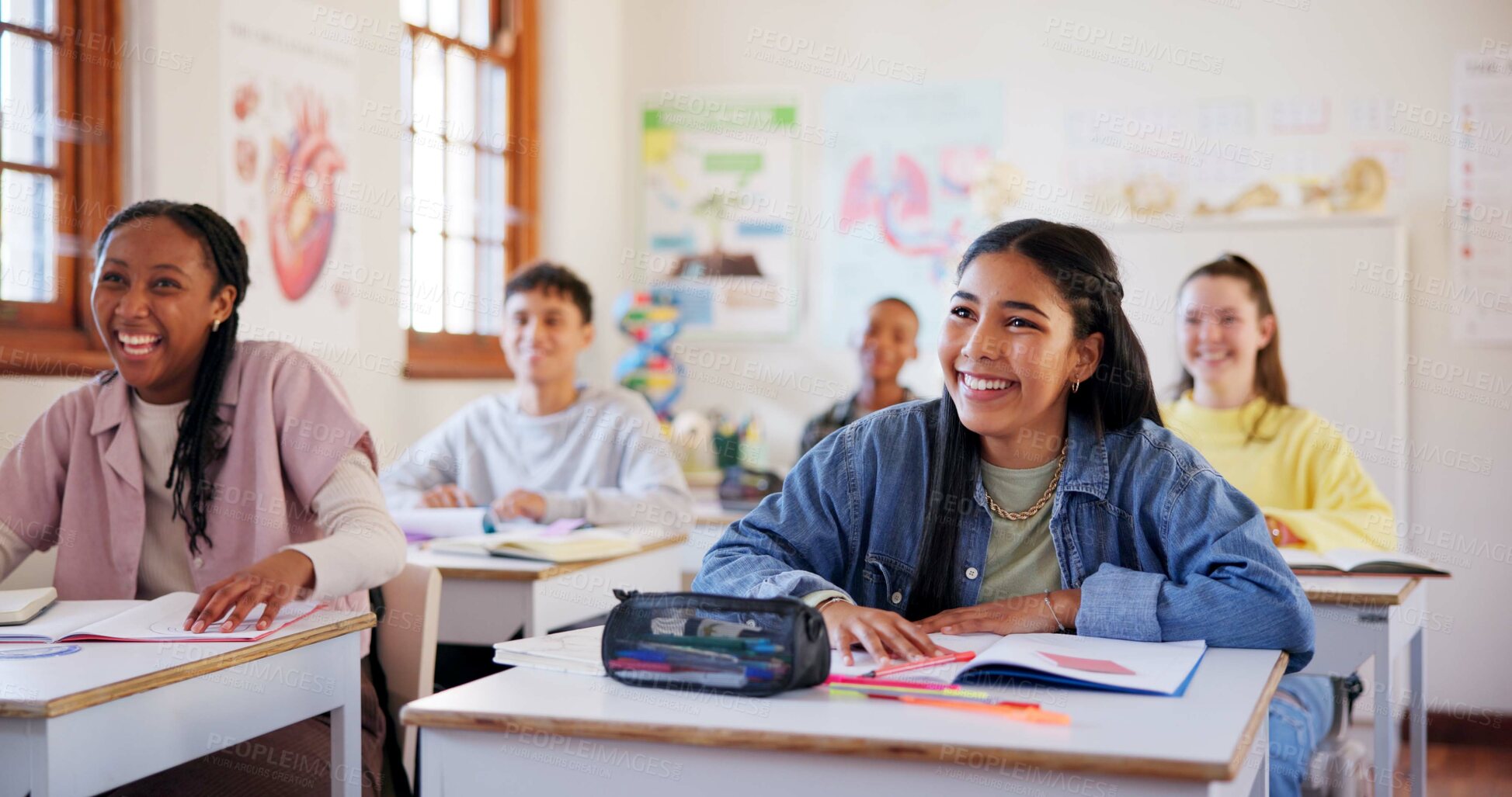 Buy stock photo Happy teenagers, students and laughing with humor in classroom for funny joke together at school. Young, group or learners with smile, books or desk for fun education, learning or youth development