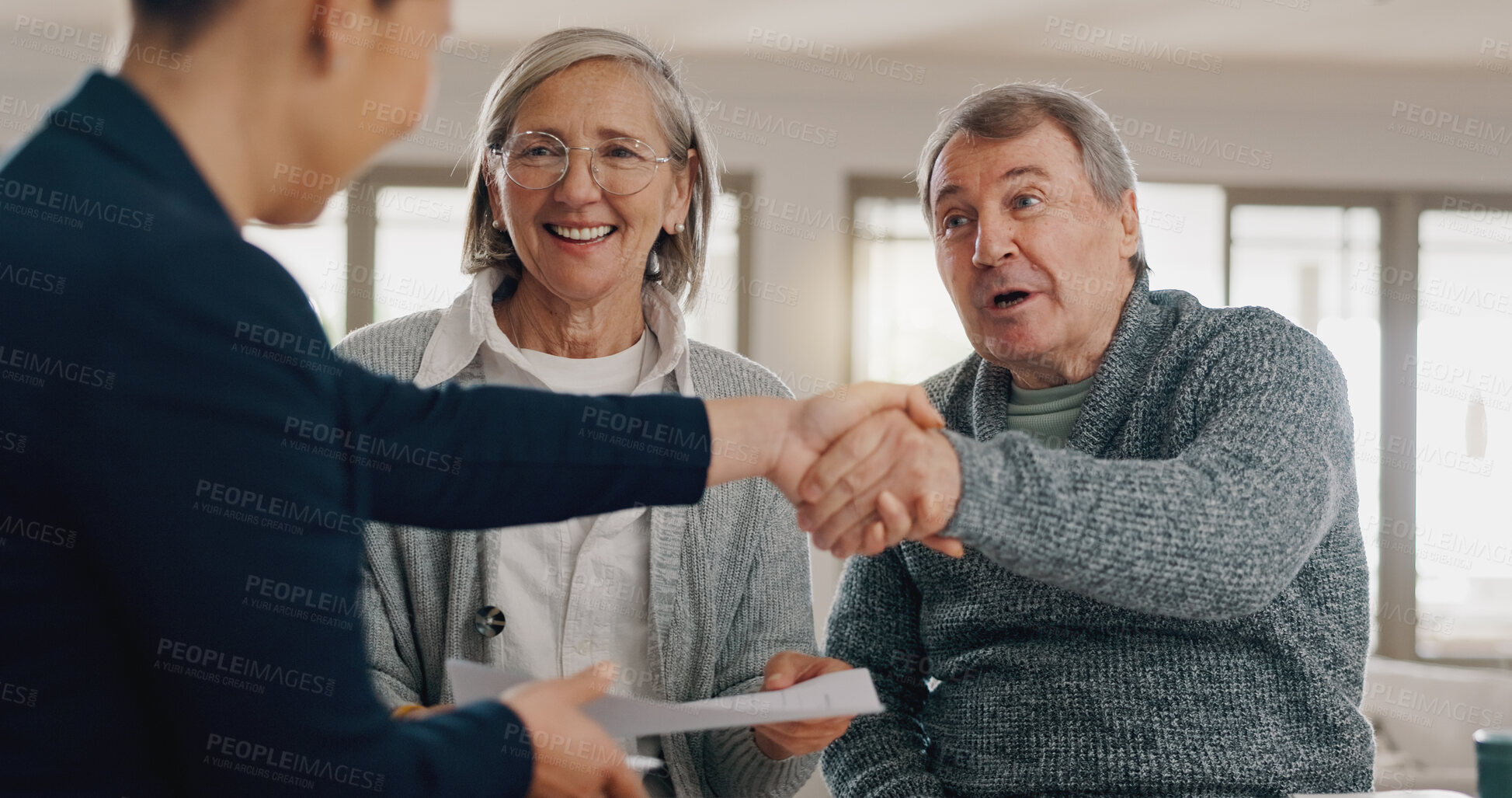 Buy stock photo Financial advisor, handshake and senior couple with documents for insurance, saving and planning. Retirement, shaking hands and person with mature man and woman with paperwork, mortgage and pension