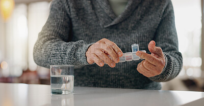 Buy stock photo Old man, hands and pill container in home, arthritis treatment and water for antibiotics or drugs. Male person, prescription and pharmaceutical organizer on table, tablets and medication for pain