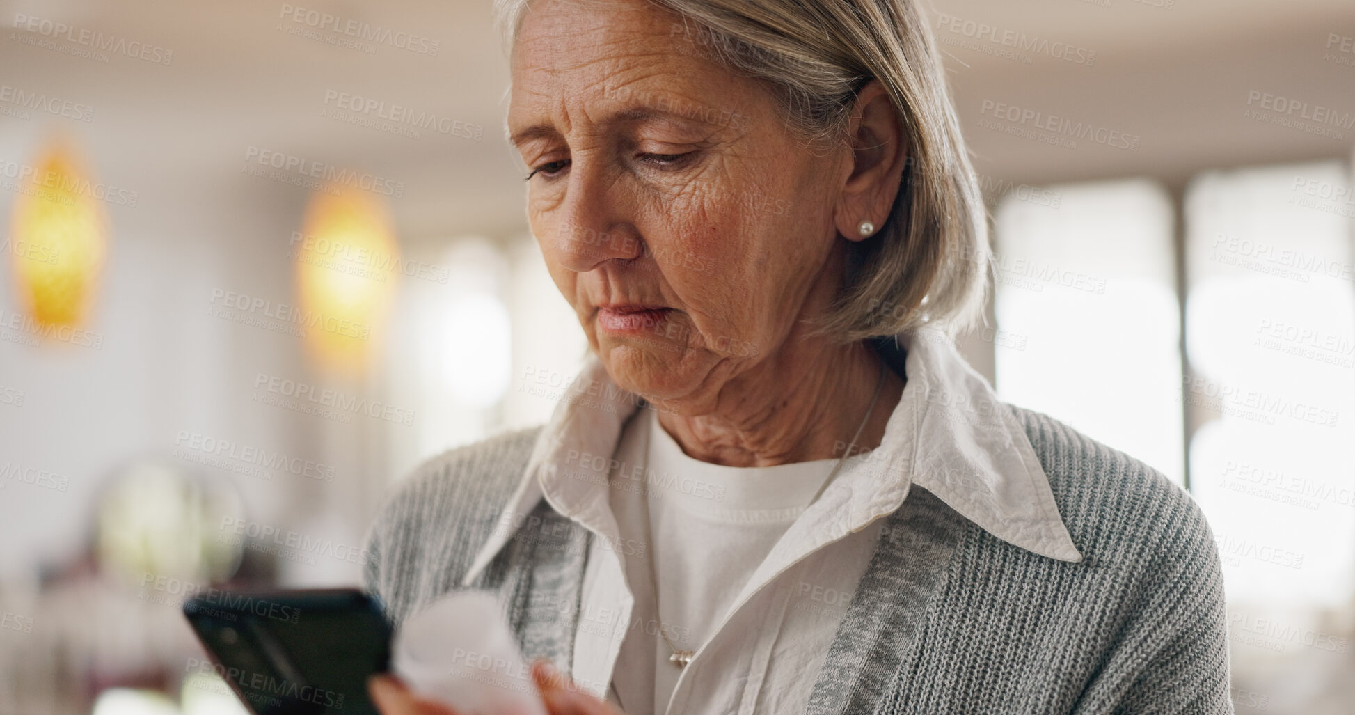 Buy stock photo Senior woman, pills and phone in home for reading side effects, benefit or allergies in retirement. Elderly person, smartphone and check for medicine, drugs or supplements with research on mobile app