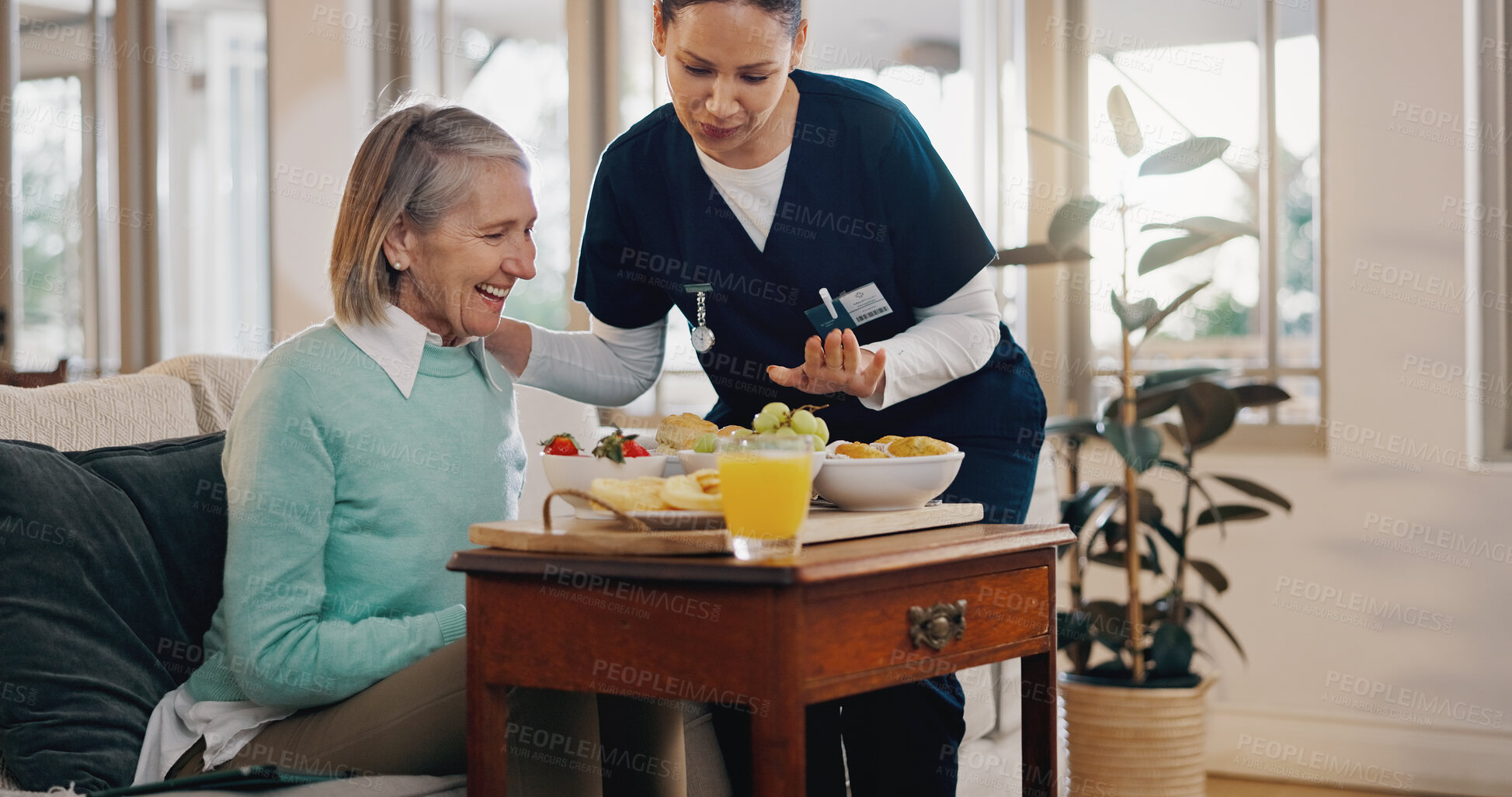 Buy stock photo Senior woman, nurse and breakfast in home with talk, support and happy with nutrition for wellness. People, caregiver and helping hand with food, fruit and advice for diet with smile in retirement