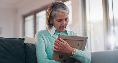 Buy stock photo Sad, hug and senior woman with picture frame for mourning, loss or grief with memory in home. Crying, nostalgia and elderly female person embracing photo for reflection or remembrance of past love.