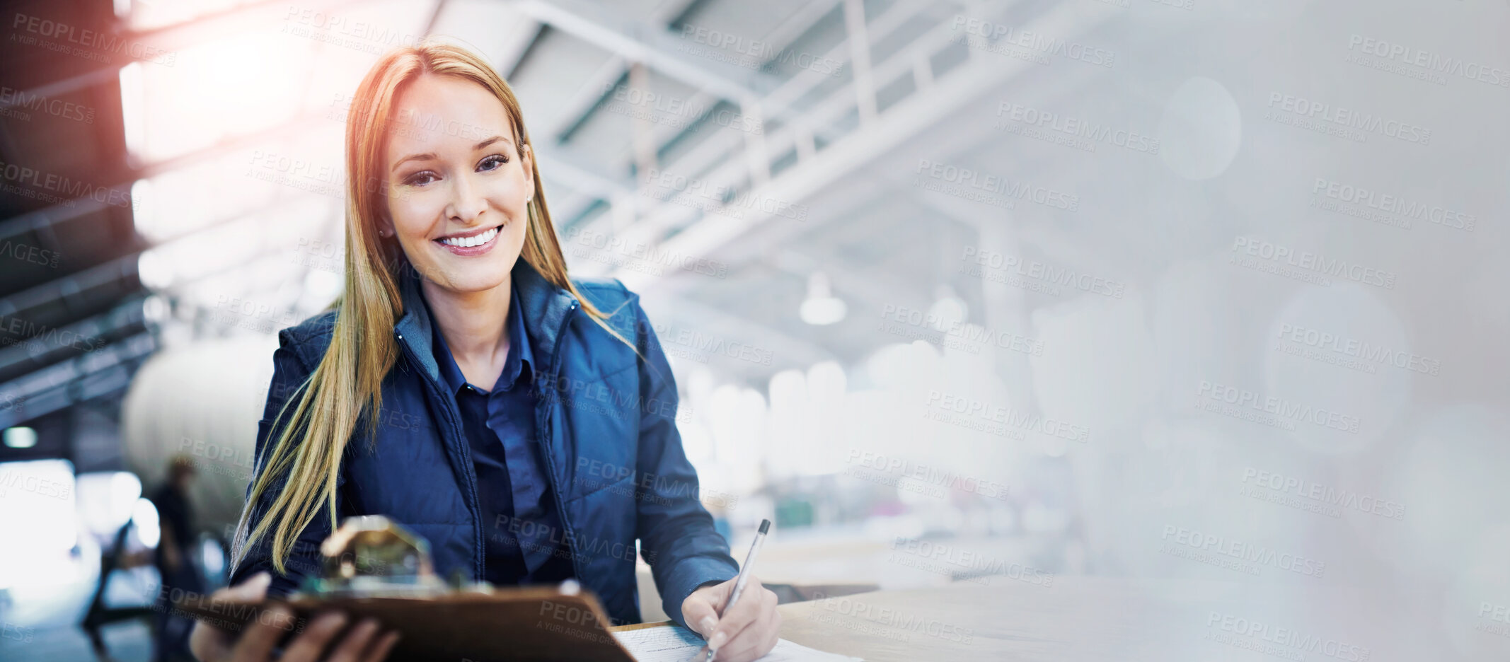 Buy stock photo Woman, supervisor and writing with clipboard in logistics at factory with machines for supply chain. Portrait, warehouse and paperwork on table in manufacturing and distribution business with smile