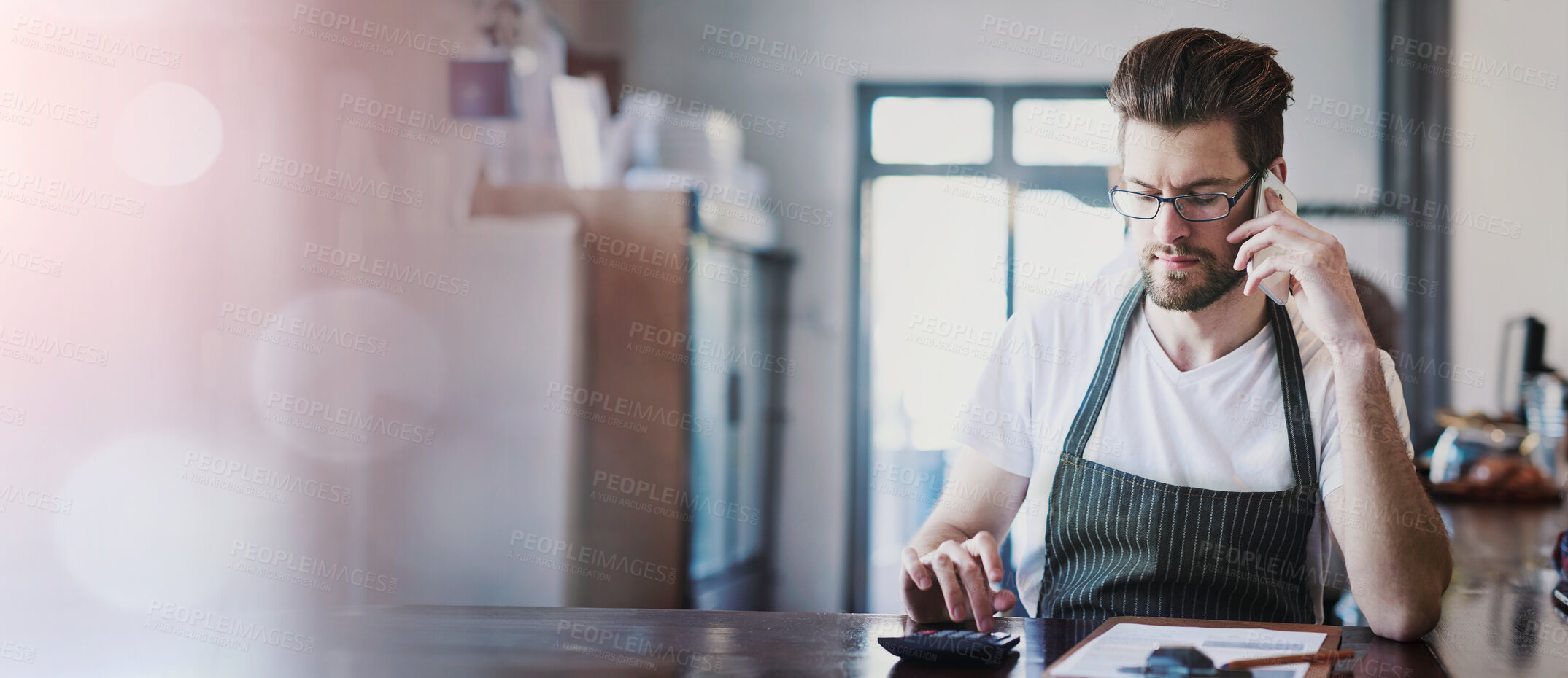 Buy stock photo Cropped shot of a young barista taking orders via cellphone