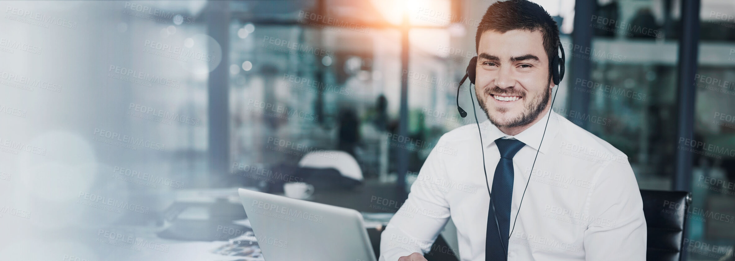 Buy stock photo Portrait of a young customer service representative wearing a headset while sitting at his workstation in an office