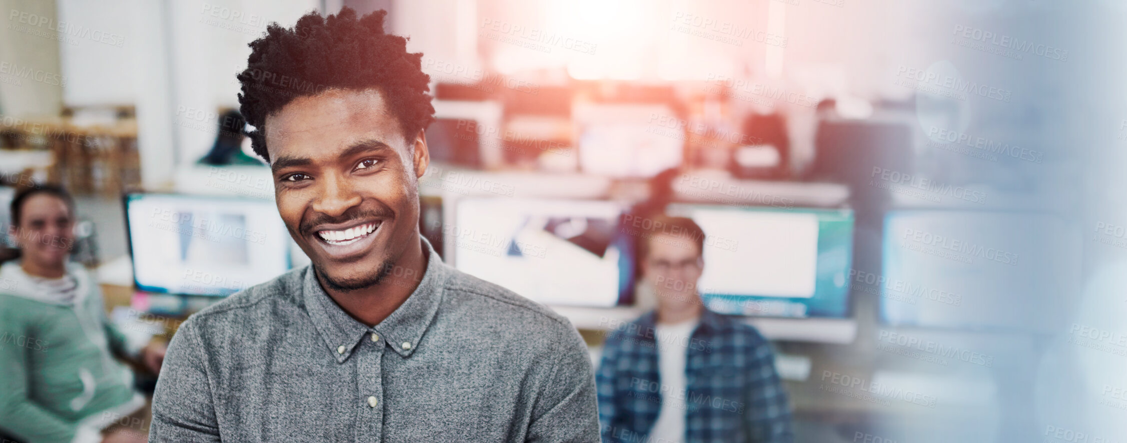 Buy stock photo Portrait of a young man standing in an office with designers in the background