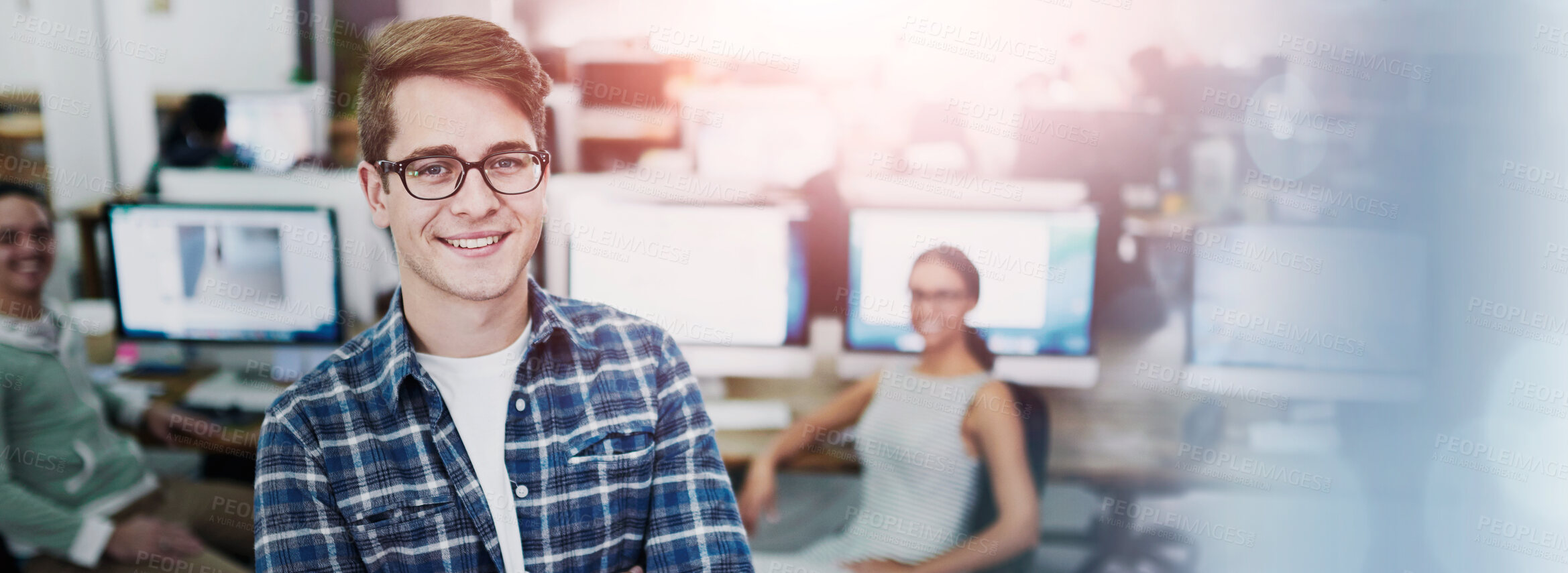 Buy stock photo Portrait of a smiling young designer standing in an office with colleagues working in the background