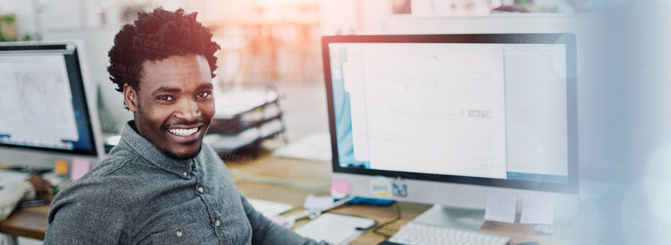 Buy stock photo Portrait of an smiling young designer sitting at a computer in an office