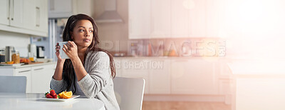 Buy stock photo Shot of young woman daydreaming while enjoying breakfast in her kitchen at home