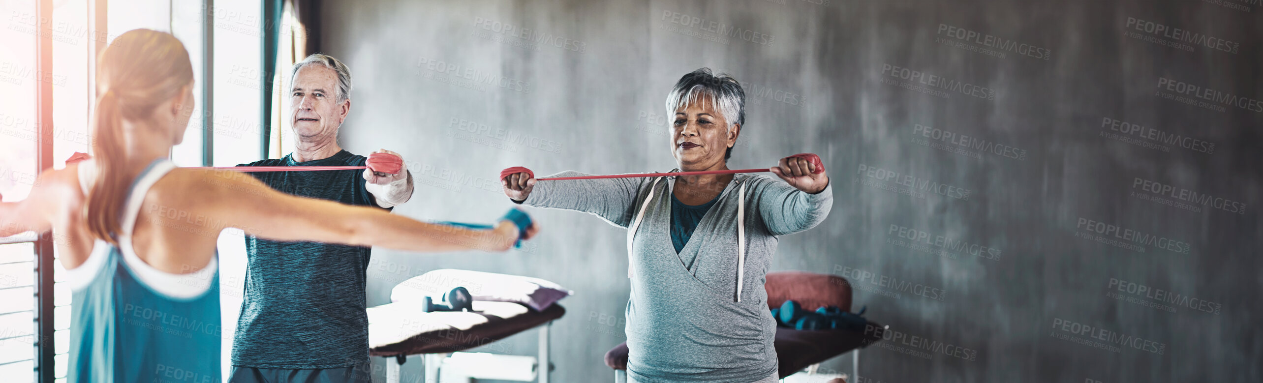 Buy stock photo Stretching band, support and senior people in physical therapy for help with muscle training by physiotherapist. Exercise, workout and strength progress of mature clients in wellness class or gym