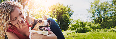 Buy stock photo Shot of a young woman bonding with her dog in the park