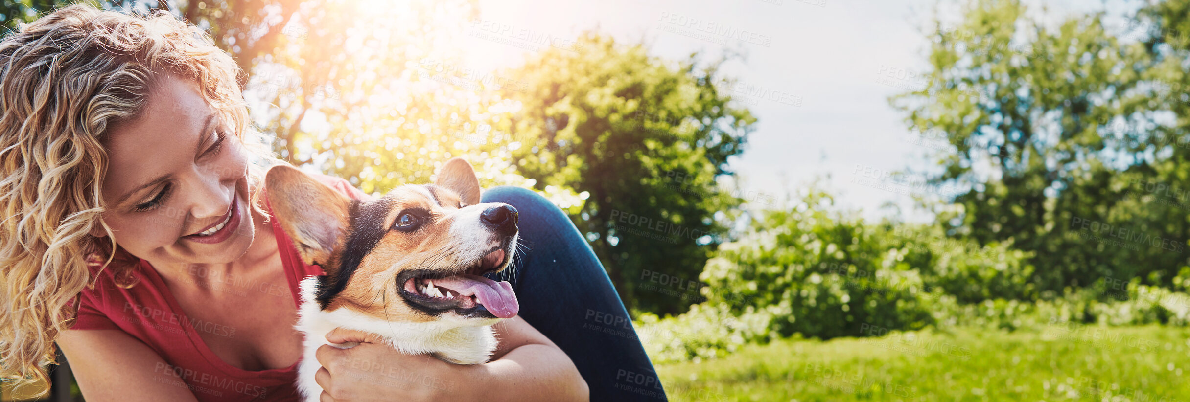 Buy stock photo Shot of a young woman bonding with her dog in the park