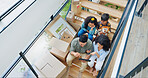 Parents, children and boxes on stairs in new house with tablet for property design and interior decoration research. Top view, family or digital app in dream home with renovation inspiration or ideas