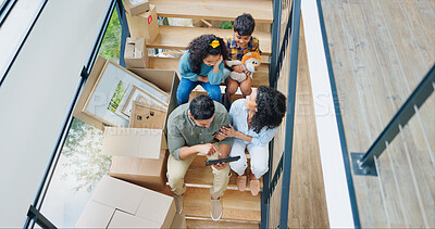 Buy stock photo Parents, children and boxes on stairs in new home with tablet for property design and interior decoration research. Top view, family or digital app in dream house with renovation inspiration or ideas