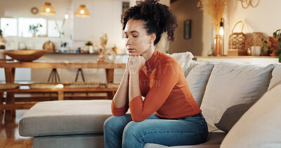 Buy stock photo Bored, depression and sad with woman on sofa in living room of home for emotional contemplation. Breakup, heartbreak and thinking with unhappy African person in apartment for loneliness or separation