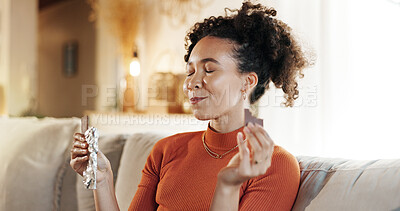 Buy stock photo Happy, woman and eating chocolate on sofa for morning snack, enjoy candy and sweet tooth for dessert. Smile, girl and eyes closed with cacao sugar for breakfast peace, comfort food and relax at house