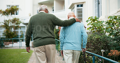 Buy stock photo Senior friends, outdoor hug and walking together, support person with disability and retirement. Back, elderly people and assistance in backyard of nursing home, bonding and embrace in relationship