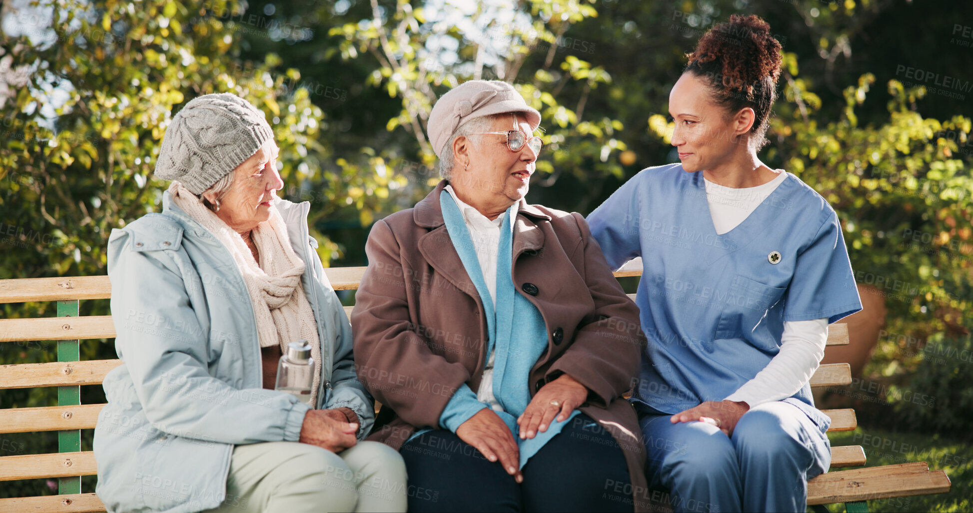 Buy stock photo Retirement, wellness and nurse with old couple on park bench for assisted living or healthcare. Love, medical or trust with senior man, woman and caregiver outdoor in nature to relax for bonding