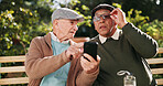 Outdoor, help and senior men with smartphone, typing and retirement with advice, texting and message. Pensioner, friends and old people on bench, cellphone and mobile user in park, network and app