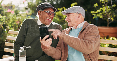 Buy stock photo Outdoor, funny and senior men with cellphone, typing and retirement with humor, texting and message. Pensioner, friends and old people on bench, smartphone and mobile user in park, network and joke