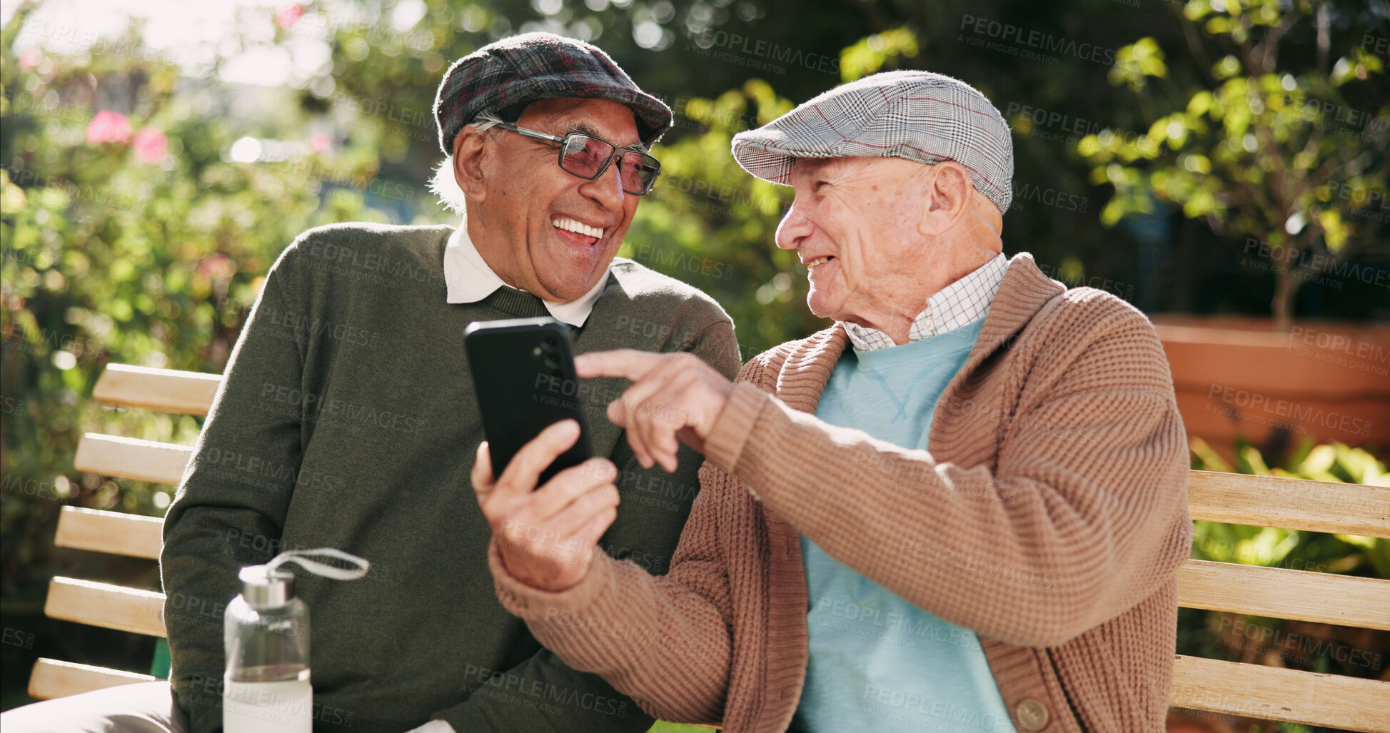 Buy stock photo Outdoor, funny and senior men with cellphone, typing and retirement with humor, texting and message. Pensioner, friends and old people on bench, smartphone and mobile user in park, network and joke