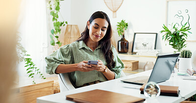 Buy stock photo Phone, reading and woman at desk in home office with laptop, smile and research for freelance project. Remote work, typing and girl with smartphone for online chat, connectivity and planning schedule