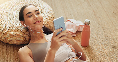 Buy stock photo Music, phone and exercise with woman in home for streaming, fitness podcast and peace. Relax, internet and wellness app with person listening to zen audio on floor for mental health, yoga and pilates