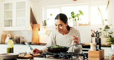 Buy stock photo Woman, cooking and smell salad in kitchen for aroma, meal prep and healthy lunch recipe by stove. Nutrition influencer, food blogger and vegan chef with smartphone for social media tutorial in home