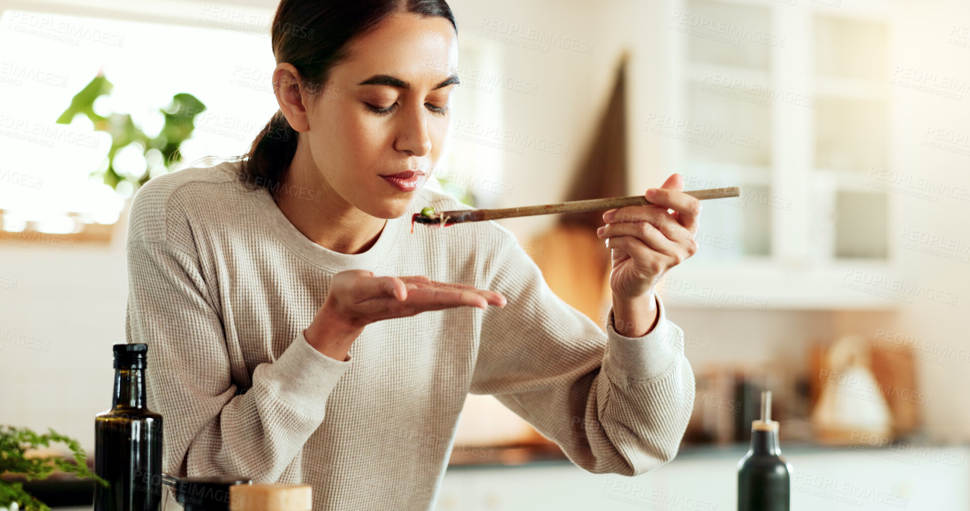 Buy stock photo Taste, cooking and woman in kitchen with food, health and wellness with delicious traditional recipe for lunch. Diet, nutrition and girl with spoon, ingredients and meal prep for dinner in home