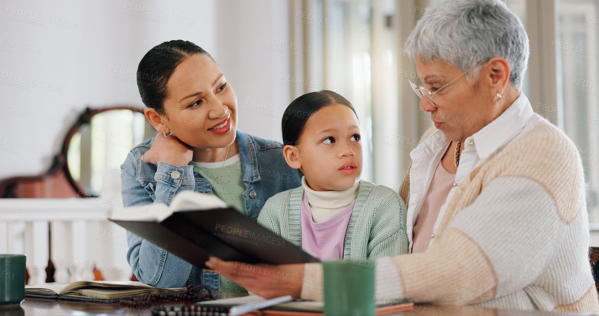 Buy stock photo Mom, kid and grandmother with bible in home for generations, worship and growth in Christian religion. Family, women and girl with scripture at table for gospel, teaching and education of Holy Spirit
