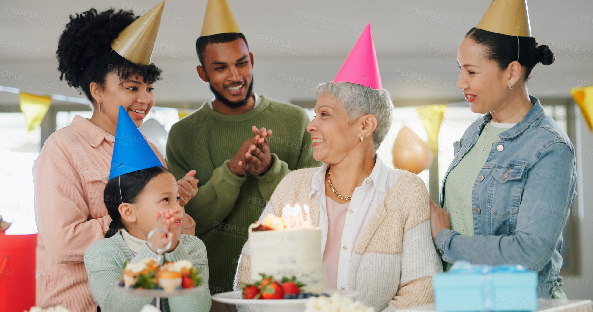 Buy stock photo Happy, family and celebration with grandmother on birthday for surprise, present and special event at home. Party hat, people and child with applause by senior woman for cake, candles and dessert