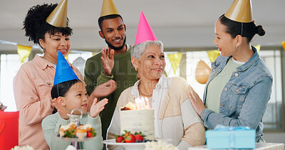 Buy stock photo Family, happy and celebration with grandma on birthday for present, surprise and special event at home. Party hat, child and people with applause by senior woman for dessert, cake or candles by table