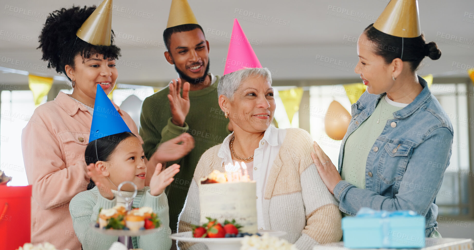 Buy stock photo Family, happy and celebration with grandma on birthday for present, surprise and special event at home. Party hat, child and people with applause by senior woman for dessert, cake or candles by table