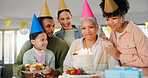 Home, family and celebration with grandmother on birthday for surprise, present and happy event. Party hat, people and child with smile by senior woman for cake, candles and support on special day