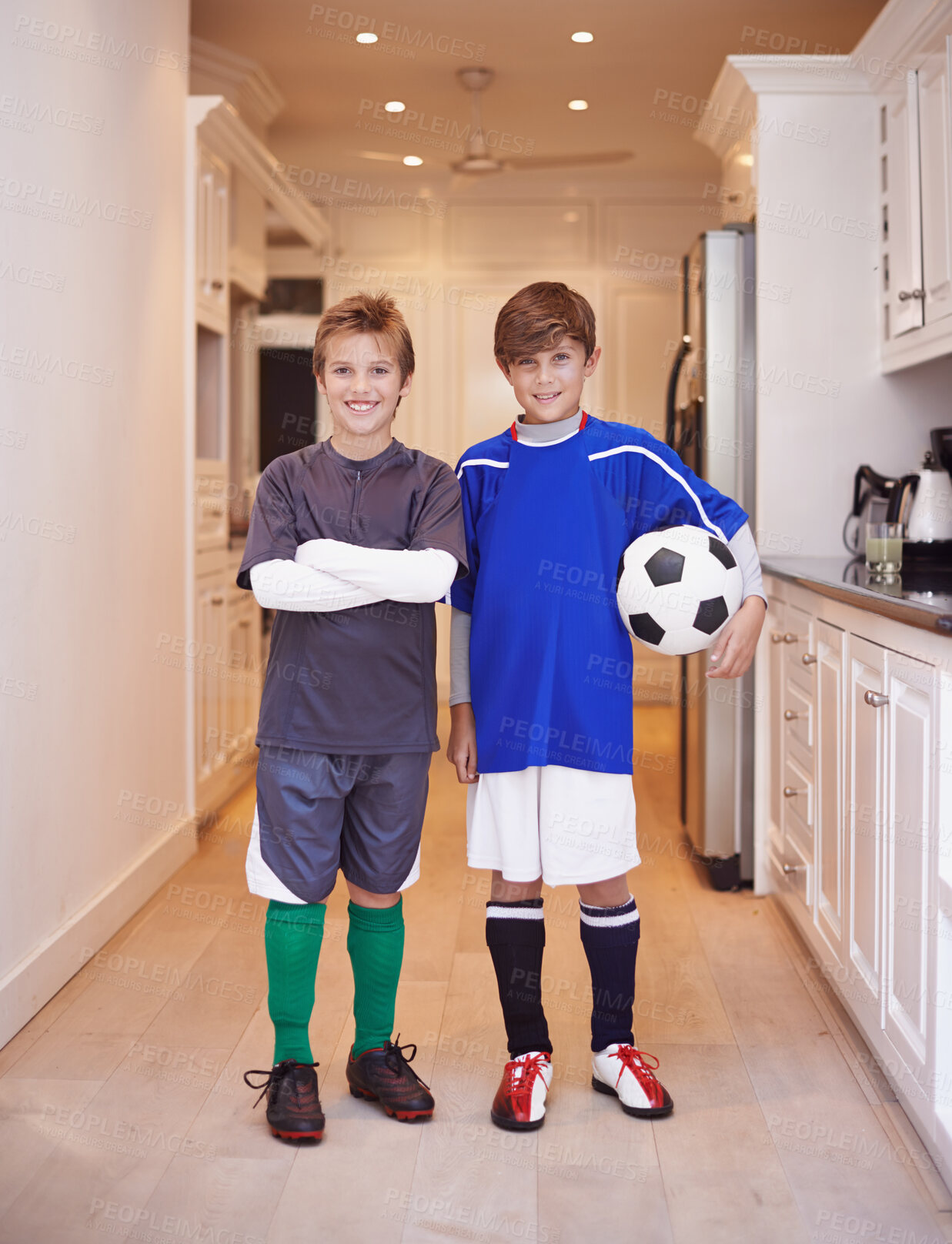 Buy stock photo Children, friends and portrait with soccer ball at house or training game in kit or competition, cardio or apartment. Male people, face and football in kitchen or player practice, exercise or workout