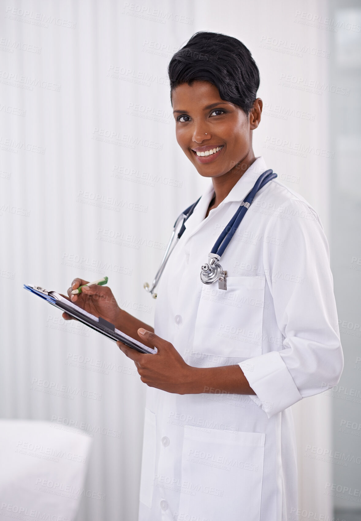 Buy stock photo Portrait, doctor and happy woman writing on checklist in hospital for healthcare career in India. Face, smile and medical professional with clipboard, employee or expert worker in clinic for wellness