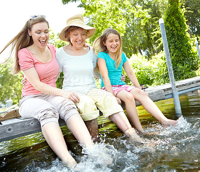 Buy stock photo Happy family, senior woman and child with splash in water for relax on holiday or vacation in river. Grandmother, daughter and kid in bonding together for love, support and care as generations in USA