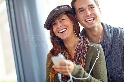 Buy stock photo Laugh, music and journey with couple at bus station. for holiday, streaming and smile together. Audio, public transportation and podcast with people at subway for support, adventure and date