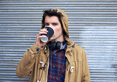 Buy stock photo Man, portrait and drink coffee outdoor for travel, relax and break with headphones, hoodie or takeaway cup. Male person, face and latte by sidewalk for winter, tourism or warm beverage in morning