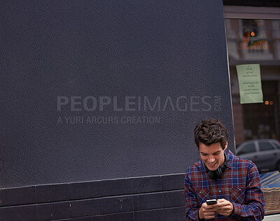 Buy stock photo Man, reading and texting in street with phone, chat and happy for notification with mobile app for connection. Person, smartphone and click with contact, smile and scroll with social media in city