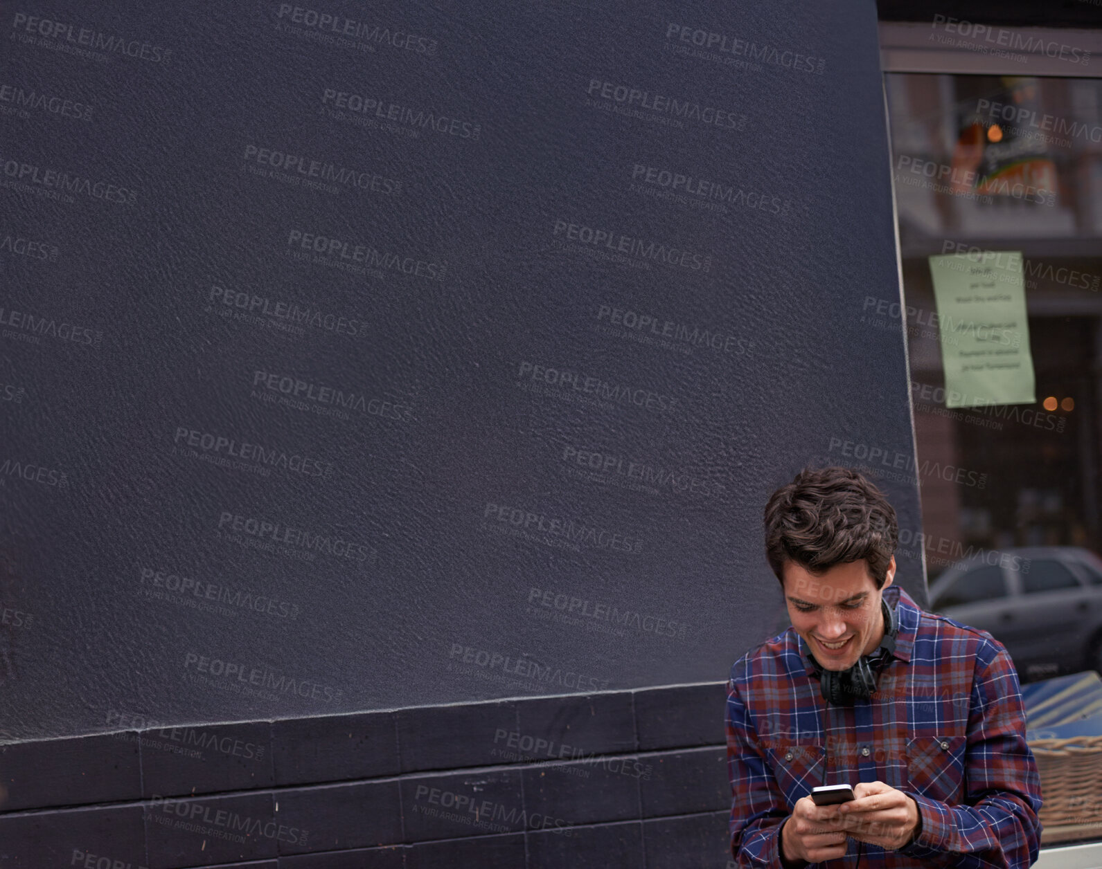 Buy stock photo Man, reading and texting in street with phone, chat and happy for notification with mobile app for connection. Person, smartphone and click with contact, smile and scroll with social media in city