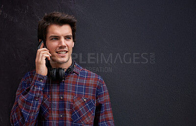 Buy stock photo Man, phone call and happy by wall in city with chat, listening and conversation with mobile connection. Person, smartphone and college student with contact, smile or outdoor on metro street in Italy