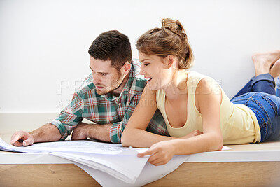 Buy stock photo New home, blueprints and couple on floor, architecture and conversation for renovation. Happy people, apartment and man with woman, documents and mortgage with cooperation, real estate and property