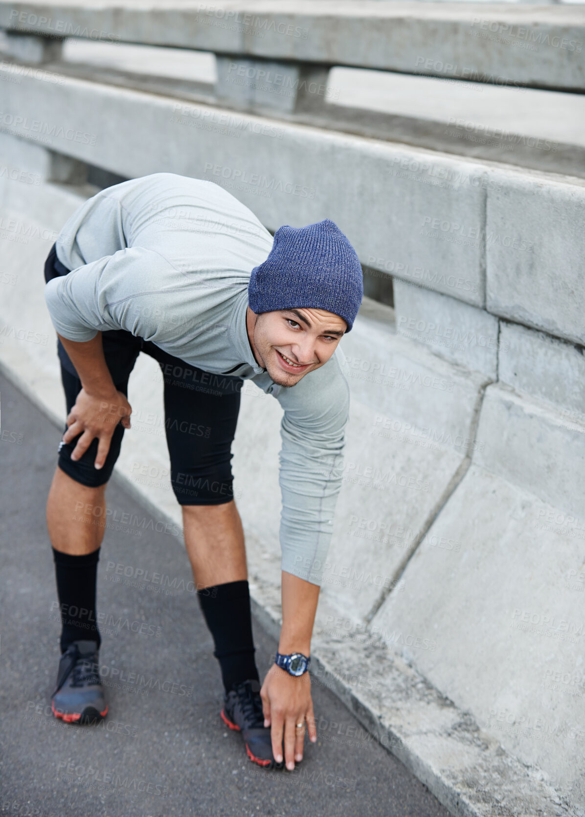 Buy stock photo Man portrait, city and stretching legs for fitness, bridge challenge and morning for cardio workout. Male person, warm up and urban town for muscle relief, outdoor and athlete for start of training